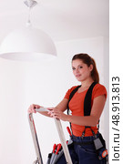 Woman on a stepladder. Стоковое фото, агентство Ingram Publishing / Фотобанк Лори