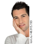 Man with gelled hair and his chin resting in his hand. Стоковое фото, агентство Ingram Publishing / Фотобанк Лори