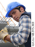 Construction worker with slabs of reinforced concrete. Стоковое фото, агентство Ingram Publishing / Фотобанк Лори