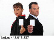 Businessman and woman holding calling cards. Стоковое фото, агентство Ingram Publishing / Фотобанк Лори