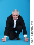 Businessman attempting to lift. Стоковое фото, агентство Ingram Publishing / Фотобанк Лори
