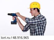 Tradesman holding a power tool. Стоковое фото, агентство Ingram Publishing / Фотобанк Лори