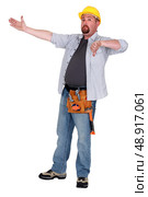 Tradesman pointing to an object and giving the thumb’s down. Стоковое фото, агентство Ingram Publishing / Фотобанк Лори