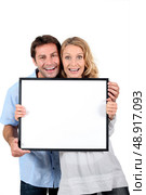 couple with blank picture frame. Стоковое фото, агентство Ingram Publishing / Фотобанк Лори