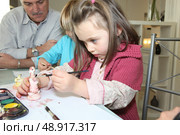 Little girl painting a figurine. Стоковое фото, агентство Ingram Publishing / Фотобанк Лори