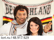Couple supporting the German football team. Стоковое фото, агентство Ingram Publishing / Фотобанк Лори