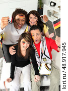A group of friends supporting the German football team. Стоковое фото, агентство Ingram Publishing / Фотобанк Лори