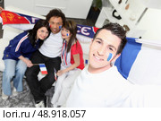 A group of friends supporting the French football team. Стоковое фото, агентство Ingram Publishing / Фотобанк Лори