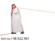 Arab in tug of war concept on white. Стоковое фото, агентство Ingram Publishing / Фотобанк Лори