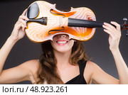 Woman artist with violin in music concept. Стоковое фото, агентство Ingram Publishing / Фотобанк Лори