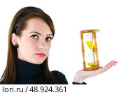 Woman with hourglass isolated on the white. Стоковое фото, агентство Ingram Publishing / Фотобанк Лори