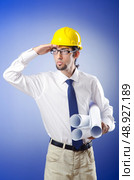 Young engineer working with drawings. Стоковое фото, агентство Ingram Publishing / Фотобанк Лори