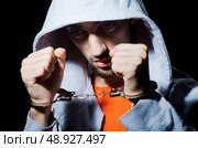 Young criminal with handcuffs. Стоковое фото, агентство Ingram Publishing / Фотобанк Лори