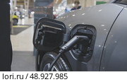 An electro car on charge at the charging station indoors. Стоковое видео, видеограф Константин Шишкин / Фотобанк Лори