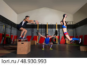 gym people group workout barbells slam balls and jump exercises. Стоковое фото, агентство Ingram Publishing / Фотобанк Лори