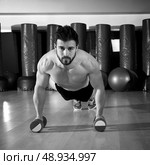 Dumbbells push-ups pushups beard man at fitness gym workout. Стоковое фото, агентство Ingram Publishing / Фотобанк Лори