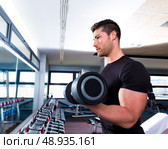 Dumbbell man at gym workout biceps fitness weightlifting. Стоковое фото, агентство Ingram Publishing / Фотобанк Лори