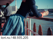 A young woman in a sailor outfit is relaxing on a boat on the Thames in London, England. Стоковое фото, агентство Ingram Publishing / Фотобанк Лори
