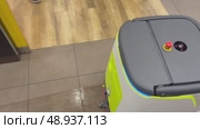 An autonomous cleaning robot moving across the shiny floor of the Vkusno i Tochka restaurant, emphasizing its modern technologies, Vkusno i tochka, Russia, Moscow, 05.05.2025. Редакционное видео, видеограф Терехова Марина / Фотобанк Лори