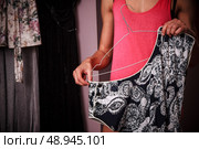 Woman trying on dresses. Стоковое фото, агентство Ingram Publishing / Фотобанк Лори
