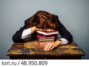 Tired Businesswoman with stack of books. Стоковое фото, агентство Ingram Publishing / Фотобанк Лори