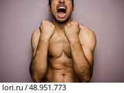 Athletic young man with his fists raised. Стоковое фото, агентство Ingram Publishing / Фотобанк Лори