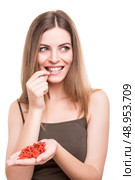 Cute girl eating a bunch of goji berries. Стоковое фото, агентство Ingram Publishing / Фотобанк Лори