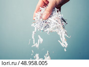 Hand is holding a bunch of shredded paper. Стоковое фото, агентство Ingram Publishing / Фотобанк Лори