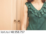 Young woman is standing next to her wardrobe. Стоковое фото, агентство Ingram Publishing / Фотобанк Лори