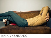 Young man relaxing on sofa. Стоковое фото, агентство Ingram Publishing / Фотобанк Лори