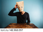 Confused man with paper bag over his head. Стоковое фото, агентство Ingram Publishing / Фотобанк Лори