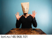 Surprised man with paper bag over his head. Стоковое фото, агентство Ingram Publishing / Фотобанк Лори