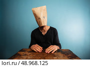 Strange man with a paper bag over his head. Стоковое фото, агентство Ingram Publishing / Фотобанк Лори