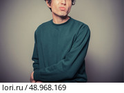 A young man is gesturing and pulling silly faces. Стоковое фото, агентство Ingram Publishing / Фотобанк Лори