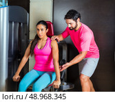 Dips press machine for triceps woman workout gym with personal trainer. Стоковое фото, агентство Ingram Publishing / Фотобанк Лори