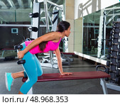 dumbbell triceps kickback girl workout exercise at gym. Стоковое фото, агентство Ingram Publishing / Фотобанк Лори