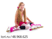 blond pigtails roller skate girl sitting happy on white background. Стоковое фото, агентство Ingram Publishing / Фотобанк Лори