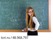 Clever nerd pupil blond girl in green chalk board student schoolgirl. Стоковое фото, агентство Ingram Publishing / Фотобанк Лори