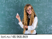 Clever nerd pupil blond girl in green board thinking student schoolgirl. Стоковое фото, агентство Ingram Publishing / Фотобанк Лори