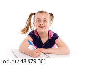 Blond kid indented girl student with spiral notebook in pupil desk. Стоковое фото, агентство Ingram Publishing / Фотобанк Лори