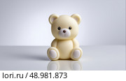 Cute yellow teddy bear figurine sitting on a reflective surface indoors. Стоковое AI-изображение, AI-художник Katsiaryna Repich / Фотобанк Лори