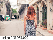 A young caucasian woman is walking in Manila. Стоковое фото, агентство Ingram Publishing / Фотобанк Лори