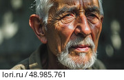 A close-up of an old man's face streaked with sadness and thoughtful as he listens to a lamentation song, the shadows of tree branches dancing across his face. Стоковое AI-видео, аниматор Sergey Grishin / Фотобанк Лори