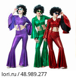 Disco style girls in colorful flared suits and African American wigs on a white background. Seventies or eighties style. Стоковое фото, фотограф Лазаренко Светлана / Фотобанк Лори