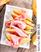 cantaloupe melon with prosciutto on a plate. Стоковое фото, агентство Ingram Publishing / Фотобанк Лори