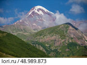 View of Mount Gasbag in the Caucasus, Georgia. Below the snow-capped peak and the Georgette glacier, the slopes are deserted and rocky. Стоковое фото, фотограф Лазаренко Светлана / Фотобанк Лори