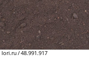 Fertile soil close-up. Richland in field. Black soil background. Natural ecological farming. Agricultural business. Humus, fertilized land. Bio agriculture and eco friendly cultivation. Rich land 4K. Стоковое видео, видеограф Марина Демидюк / Фотобанк Лори