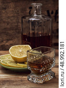 seasoned brandy into the glasses and decanter vintage style. Стоковое фото, агентство Ingram Publishing / Фотобанк Лори