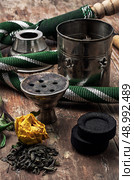details Shisha and accessories on wooden background.image is tinted in vintage style. Стоковое фото, агентство Ingram Publishing / Фотобанк Лори