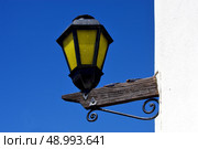 a street lamp and a wall in calle de los suspiros in colonia del sacramento uruguay. Стоковое фото, агентство Ingram Publishing / Фотобанк Лори